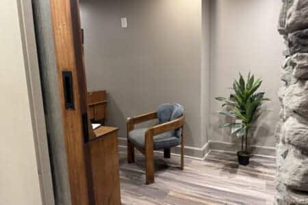 Beyond the see-through fireplace, a private office offers a quiet, inviting place for remote work, planning, reading, or reflection.