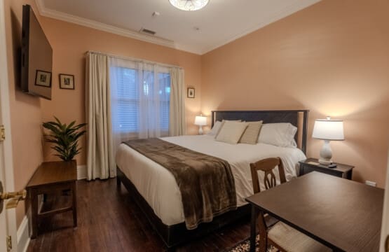 The Oaks Bedroom #3 with King Bed, Desk Area, Ceiling Fan and Private Bathroom with Tub and Shower Across the Hall