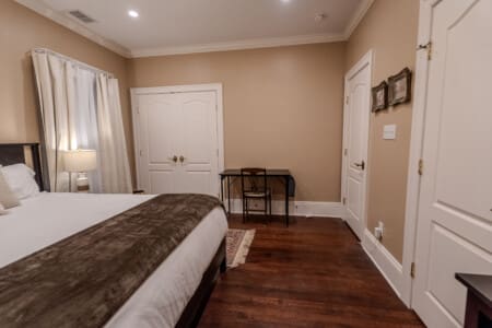 The Oaks Bedroom #2 with King Bed, Desk Area, Ceiling Fan and En Suite Full Bathroom with Shower