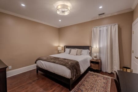 Another serene king bedroom retreat with en suite bathroom gives guests a peaceful place to rest, recharge, and enjoy privacy.