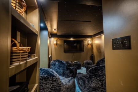 A tucked-away theater and media room pairs cave-like intimacy with a starlight ceiling, creating a cozy setting for movies, game systems, presentations, or quiet evenings together.
