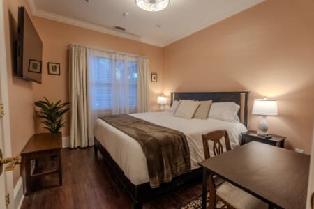 A cozy bedroom with a nearby hall bathroom, layered textures, and thoughtful details creates a restful setting for overnight guests.