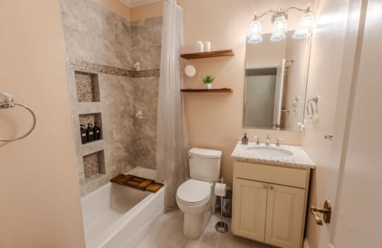 A well-appointed bathroom pairs with a nearby bedroom retreat to provide privacy, ease, and comfort for overnight stays.