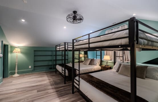 The Oaks Bedroom #5 with Four (4) Queen Bunk Beds, Built-In Desk Area, Ceiling Fan and En Suite Bathroom with Tub and Shower