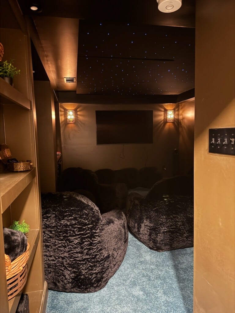 A comfy, cozy theater space invites guests to watch, play, unwind, and enjoy a quieter, more intimate viewing experience.