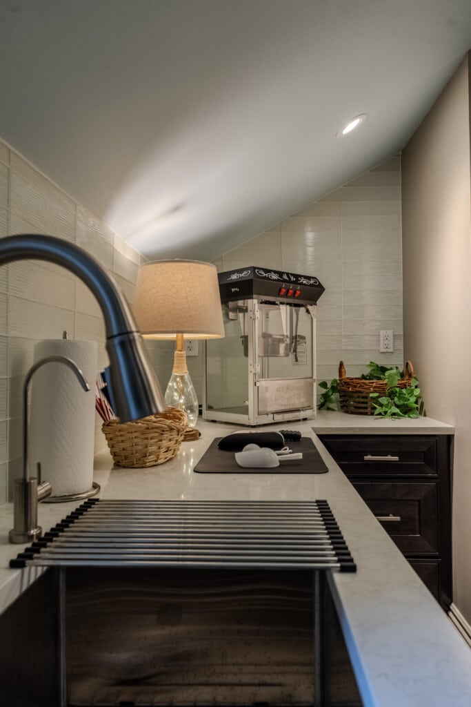 The concessions area—with popcorn, filtered water, and a mini-fridge—keeps refreshments close at hand for movie nights, game days, and group fun.