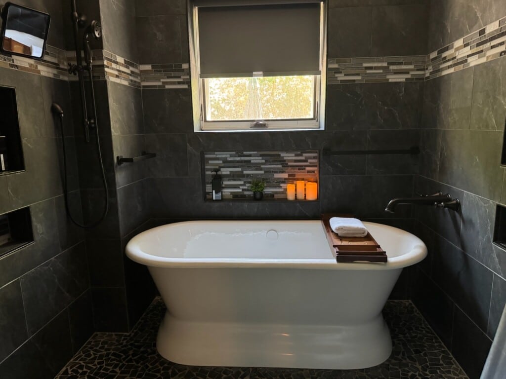 A soaking tub invites guests to unwind after travel, events, meetings, or a full day exploring Raleigh.