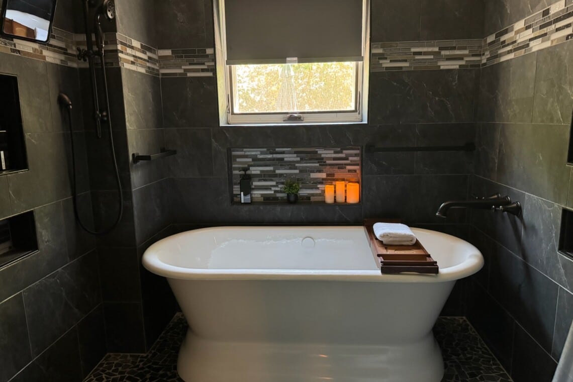 A soaking tub invites guests to unwind after travel, events, meetings, or a full day exploring Raleigh.