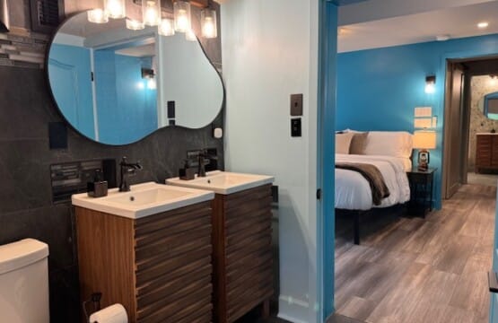 Dual vanities, carefully placed niches, and a natural flow to the bedroom add convenience, privacy, and a sense of retreat.